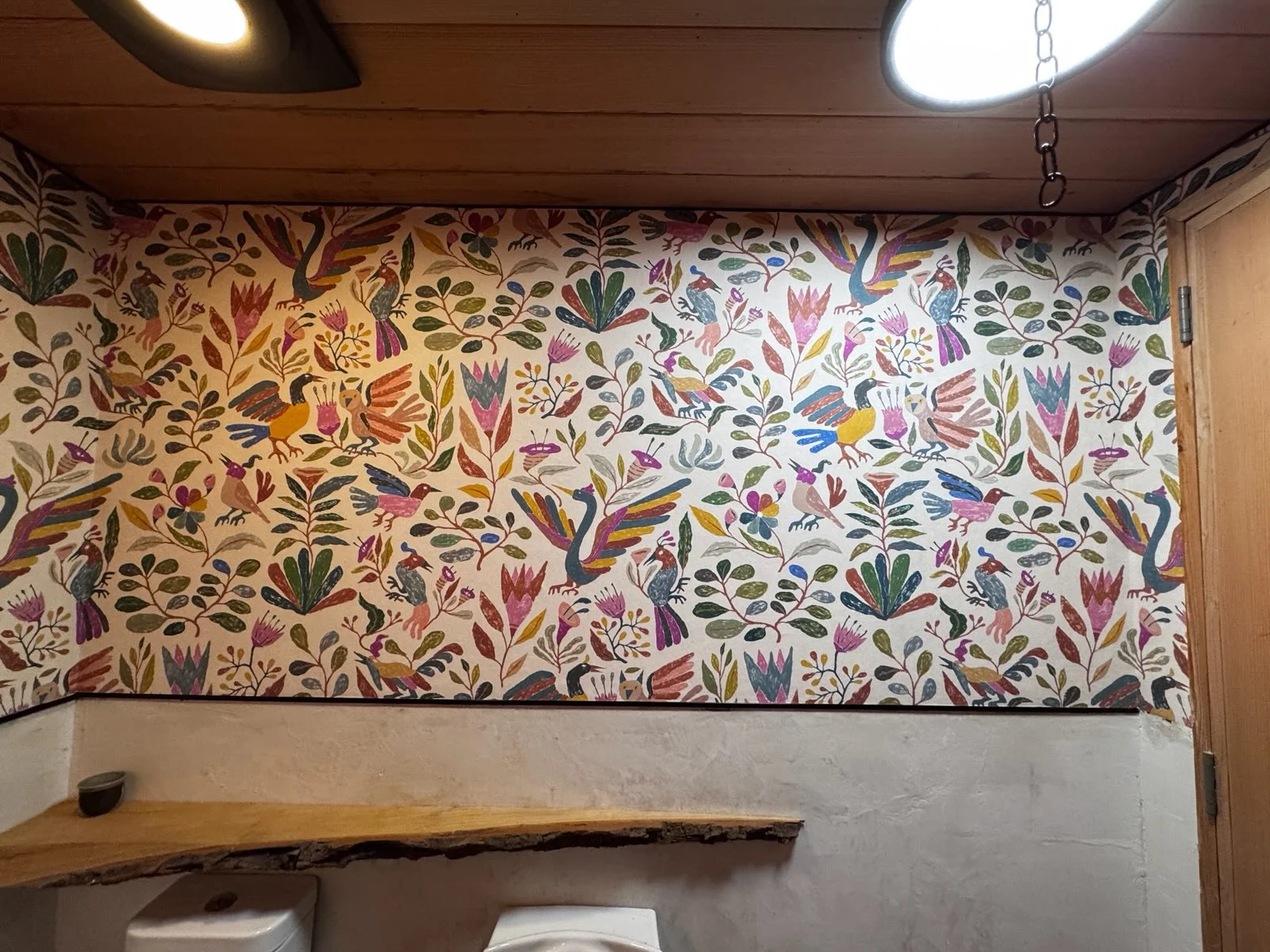 Professional wallpaper installer working in a bright interior